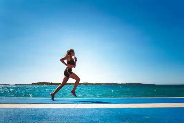 Woman running showing strong leg muscle Wakefield
